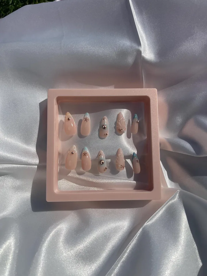 Seashell inspired nail art in a pink display frame